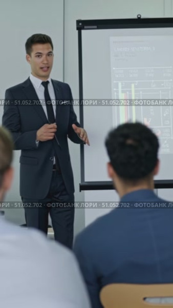 Engaging Corporate Presentation: A Professional Man Leads an Informative Session Followed by a Confident Businesswoman in a Meeting Setting with Data Visualizations. Стоковое AI-видео, аниматор Владимир Федоров / Фотобанк Лори