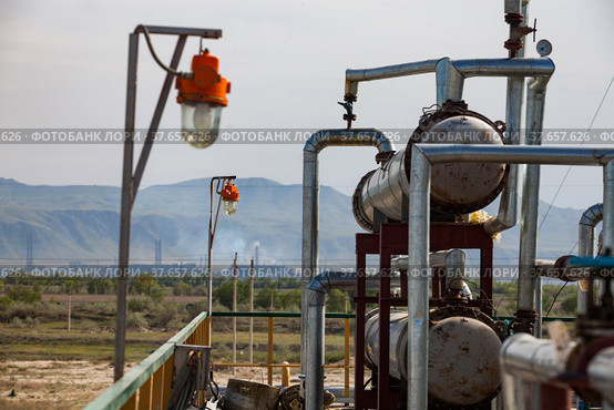 Equipment on oil refinery plant on the sky and mountain background. Kazakhstan, Taraz city. Стоковое фото, фотограф Alexey Rezvykh / Фотобанк Лори