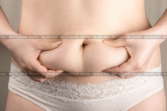 Excessive belly fat, overweight concept. woman with fat belly, overweight female body, concept of dieting, losing weight. Стоковое фото, фотограф Павел Муравьев / Фотобанк Лори