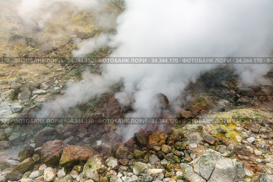 Exciting view of volcanic landscape, erupting fumarole, aggressive hot spring, gas-steam activity in crater of active volcano. Стоковое фото, фотограф А. А. Пирагис / Фотобанк Лори