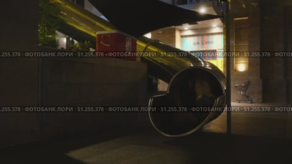 Experience nighttime fun with an illuminated slide in the city. Стоковое видео, видеограф Cantemir Dumitru / Фотобанк Лори