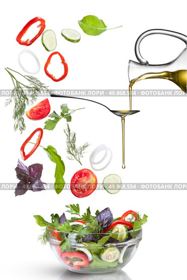 Falling vegetables for salad and oil isolated on white. Стоковое фото, агентство Ingram Publishing / Фотобанк Лори
