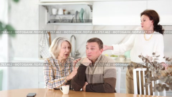 Family quarrel, old woman calming man, all are upset and dissatisfied. Family quarrel, old woman calming man. Стоковое видео, видеограф Яков Филимонов / Фотобанк Лори