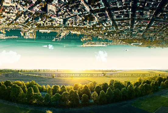 Fantastic surreal terrain of natural landscape and upside down sityscape with sea coastline. Concept of antigravity.. Natural landscape with unreal upside down sityscape. Стоковое фото, агентство Ingram Publishing / Фотобанк Лори