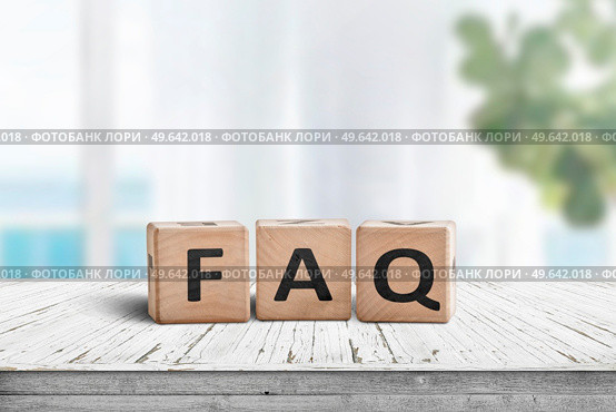 FAQ answers and questions sign made of wooden blocks. Standing on a table in a bright living area. Стоковое фото, агентство Ingram Publishing / Фотобанк Лори