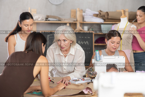 Fellow clothing designers collaborating on order in workshop. Стоковое фото, фотограф Яков Филимонов / Фотобанк Лори