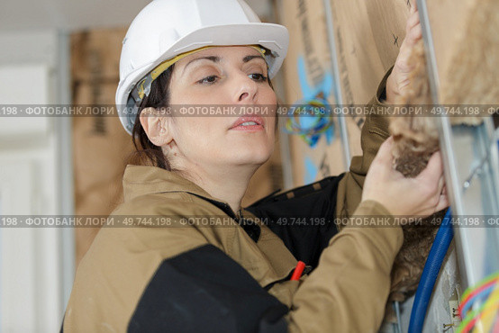female builder holding a sign or styrofoam insulation. Стоковое фото, агентство Ingram Publishing / Фотобанк Лори