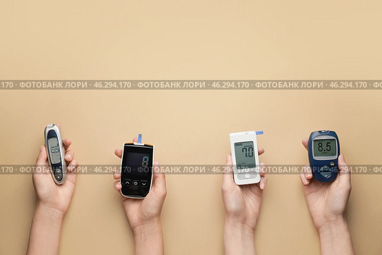 Female hands with different glucometers on color background. Diabetes concept. Стоковое фото, фотограф Pixel_shot / Фотобанк Лори