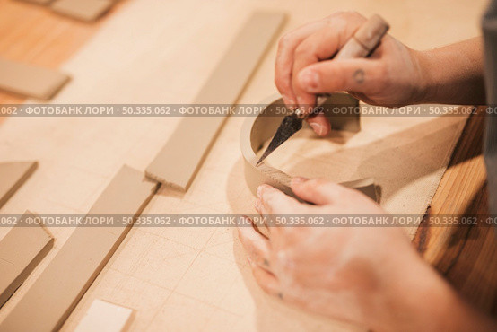 female potter s hand engraving clay with tools wooden table. Стоковое фото, агентство Ingram Publishing / Фотобанк Лори