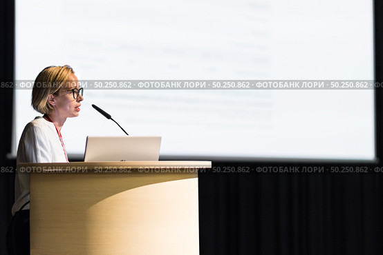 Female speaker giving a talk on corporate business conference. Business and Entrepreneurship event. Стоковое фото, фотограф Matej Kastelic / Фотобанк Лори