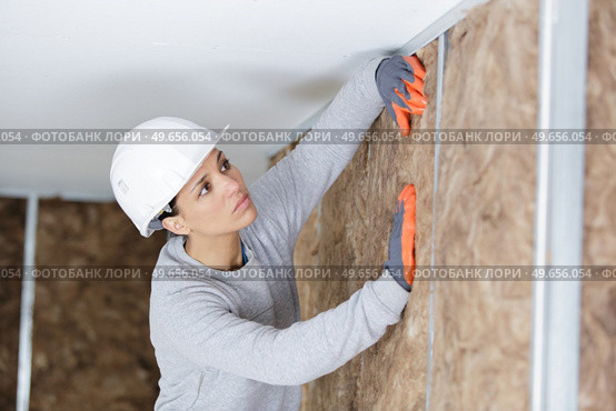 female worker at a indoors wall insulation. Стоковое фото, агентство Ingram Publishing / Фотобанк Лори