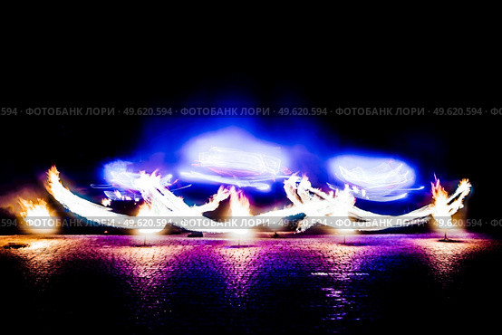 fiery pieces of a fire show against a dark sky and thunderstorms. Стоковое фото, агентство Ingram Publishing / Фотобанк Лори