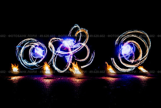 fiery pieces of a fire show against a dark sky and thunderstorms. Стоковое фото, агентство Ingram Publishing / Фотобанк Лори