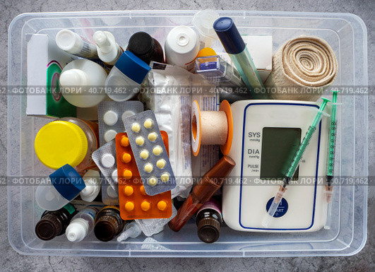 First aid kit with medicines, tonometer, thermometers, dressings, syringes, inhalers and medical supplies. Medical background with medicines and products for the prevention and treatment of diseases. Стоковое фото, фотограф Бузмакова Светлана / Фотобанк Лори