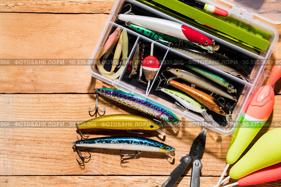 fishing float lure with plier wooden desk. Стоковое фото, агентство Ingram Publishing / Фотобанк Лори