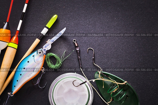 Fishing tackle on dark background. Fishing tackle. Стоковое фото, агентство Ingram Publishing / Фотобанк Лори