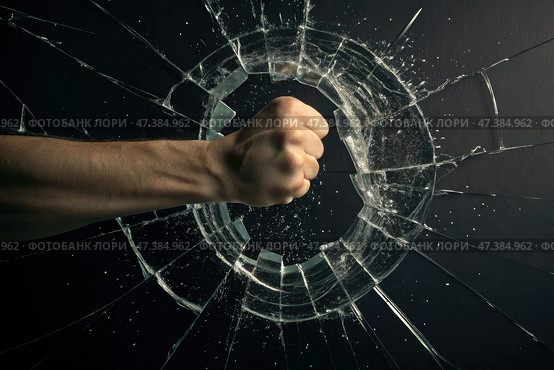 Fist forcefully breaking through glass surface, leaving a hole, dynamic energy and impact. Emphasizes strength and determination. Стоковое AI-изображение, AI-художник Коханова Наталья / Фотобанк Лори