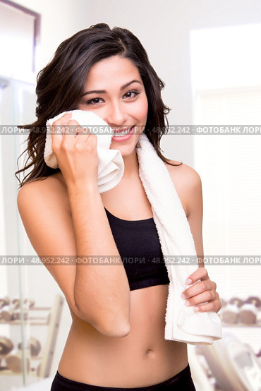 Fitness woman wiping sweat with a towel. Стоковое фото, агентство Ingram Publishing / Фотобанк Лори