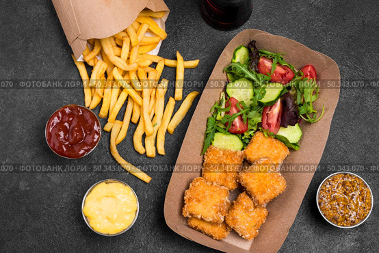 flat lay fried chicken nuggets with salad french fries. Стоковое фото, агентство Ingram Publishing / Фотобанк Лори