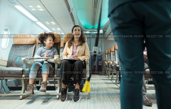 Flight attendants show how to use safety devices and recommend emergency exits. Стоковое фото, агентство Ingram Publishing / Фотобанк Лори