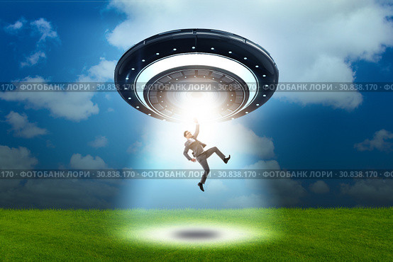 Flying saucer abducting young businessman. Стоковое фото, фотограф Elnur / Фотобанк Лори