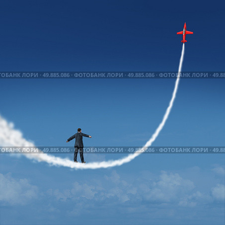 Follow your dreams concept and motivational symbol as a businessman walking upward on a smoke trail created by a jet airplane as an icon for dreaming and aspiring for growth success. Стоковое фото, агентство Ingram Publishing / Фотобанк Лори