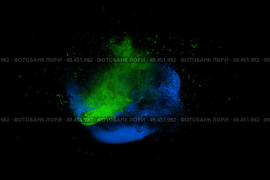 Freeze motion of blue and green powder paint exploding isolated on black, dark background. Abstract design of color dust cloud. Particles explosion screen saver, wallpaper brush. Стоковая иллюстрация, агентство Ingram Publishing / Фотобанк Лори