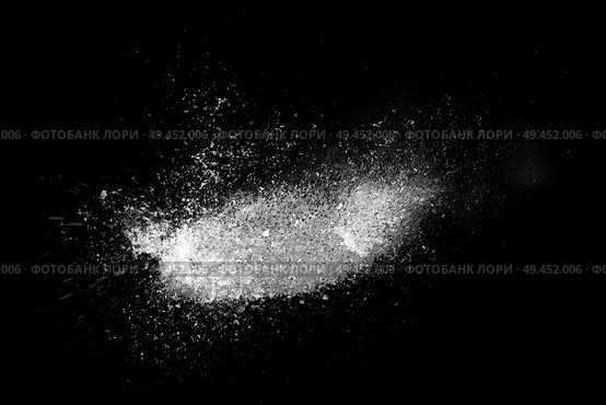 Freeze motion of white powder exploding, isolated on black, dark background. Abstract design of dust cloud. Particles explosion, screen saver wallpaper with copy space. . Стоковая иллюстрация, агентство Ingram Publishing / Фотобанк Лори
