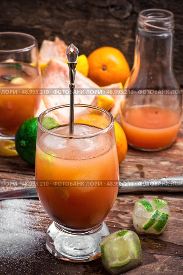 fresh tropical fruit juices. glass with drink of freshly squeezed tropical fruit with pulp.Selective focus.Photo tinted. Стоковое фото, агентство Ingram Publishing / Фотобанк Лори