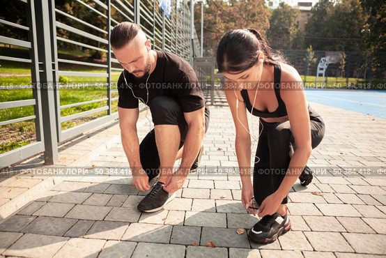 friends outdoor training bind their shoelaces. Стоковое фото, агентство Ingram Publishing / Фотобанк Лори