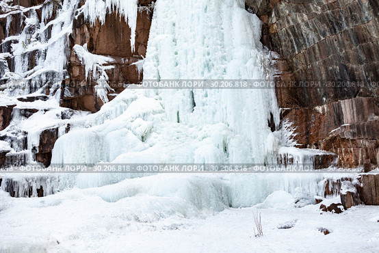 Frozen ice on rocks from a waterfall in the mountains. Стоковое фото, фотограф Restyler Viacheslav / Фотобанк Лори