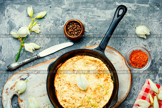 Frying pan with scrambled eggs stuffed with edible yucca flowers.American food. Omelet with edible flowers. Стоковое фото, агентство Ingram Publishing / Фотобанк Лори