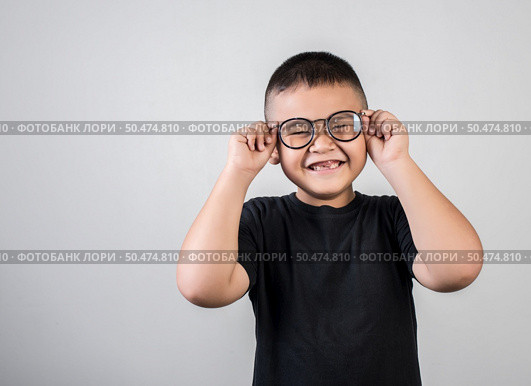 Funny boy genius wearing glasses in studio shot. Стоковое фото, агентство Ingram Publishing / Фотобанк Лори