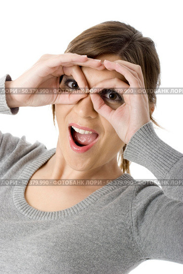 Funny portrait of a beautiful young woman doing gestures with hands - funny look. Стоковое фото, агентство Ingram Publishing / Фотобанк Лори