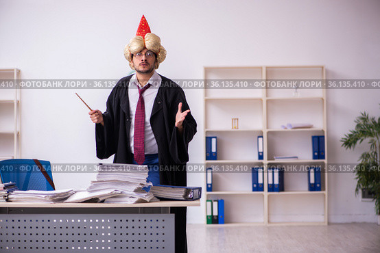 Funny young male employee magician and too much work in the office. Стоковое фото, фотограф Elnur / Фотобанк Лори