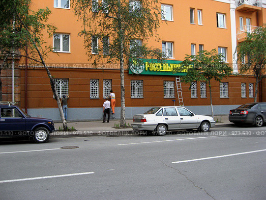 Галантный работник Сельхозбанка помогает мыть окна (2009 год). Редакционное фото, фотограф Анатолий Матвейчук / Фотобанк Лори