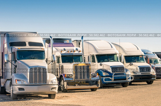 Generic semi Trucks at a parking lot. Стоковое фото, агентство Ingram Publishing / Фотобанк Лори