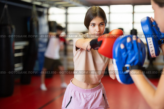 Girl in boxing gloves hits punch mitts. Стоковое фото, фотограф Яков Филимонов / Фотобанк Лори