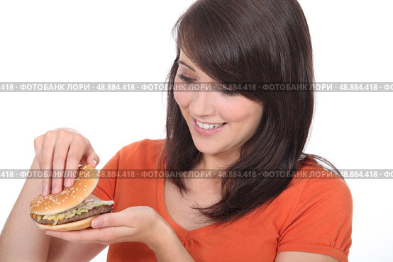 Girl looking burger. Стоковое фото, агентство Ingram Publishing / Фотобанк Лори