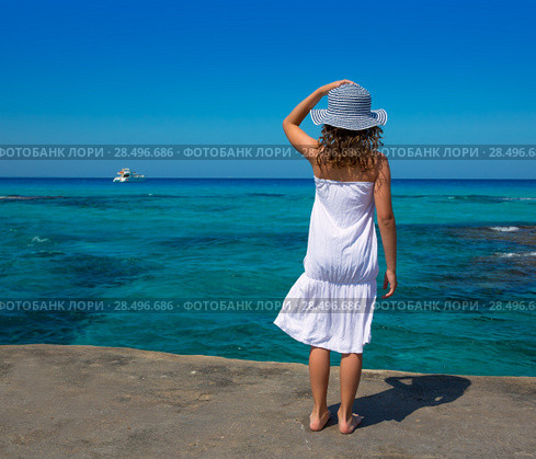 Girl rear view in Formentera Ibiza beach turquoise Mediterranean sea background. Стоковое фото, фотограф Tono Balaguer / Ingram Publishing / Фотобанк Лори