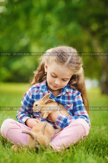 Girl with a cute little rabbit, outdoor, summer day. Стоковое фото, фотограф Чирцова Наталья / Фотобанк Лори