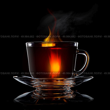 glass cup with tea and saucer isolated on black background close-up. Glass cup of tea isolated on black. Стоковое фото, агентство Ingram Publishing / Фотобанк Лори