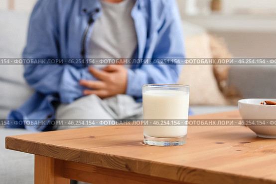 Glass of milk and little boy with dairy allergy at home. Стоковое фото, фотограф Pixel_shot / Фотобанк Лори