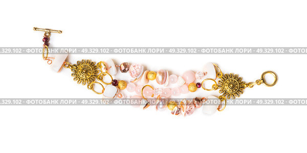 gold bracelet with pearls and pink quartz at white background. Стоковое фото, агентство Ingram Publishing / Фотобанк Лори