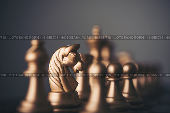 Gold chess pieces on a chessboard. Стоковое фото, агентство Ingram Publishing / Фотобанк Лори