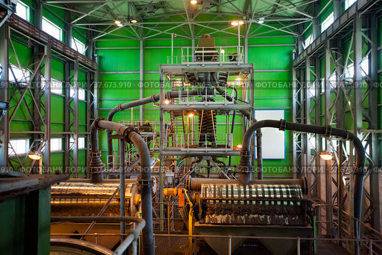 Gold ore modern refining plant. Gold gravity spiral chute concentrator (tin ore spiral) and magnetic drum separators on background. Стоковое фото, фотограф Alexey Rezvykh / Фотобанк Лори