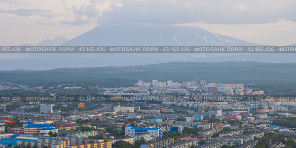 Город Петропавловск-Камчатский, Камчатский край, Дальний Восток России. Утренний городской пейзаж. Вид сверху на здания и улицы. Жилые городские районы на рассвете. Корякский вулкан вдалеке. Камчатка. Стоковое фото, фотограф Андрей Степанов / Фотобанк Лори