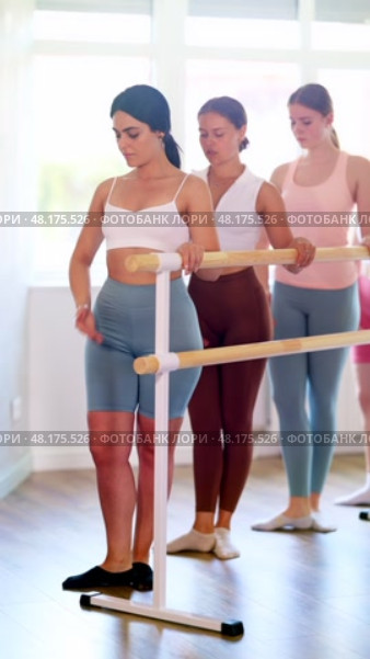 Group of enthusiastic young female ballet students focused on mastering graceful Demi rond de jambe par terre exercise at barre in mirrored well-lit choreography studio. Стоковое видео, видеограф Яков Филимонов / Фотобанк Лори