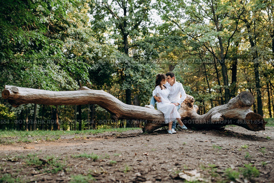 guy and a girl walk along the paths of a forest park between tall trees. Стоковое фото, агентство Ingram Publishing / Фотобанк Лори