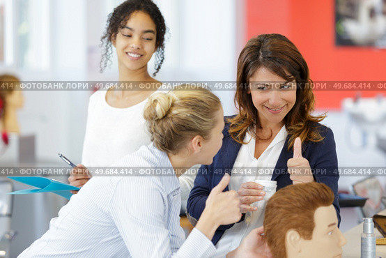 hairdresser apprentice learning to do a hairdo. Стоковое фото, агентство Ingram Publishing / Фотобанк Лори